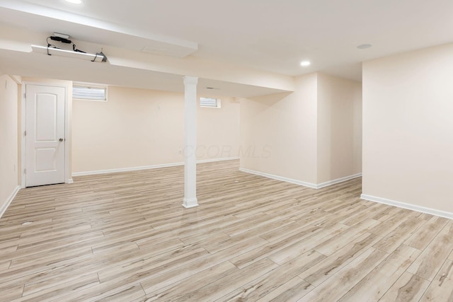below grade area featuring light wood-style floors, recessed lighting, and baseboards