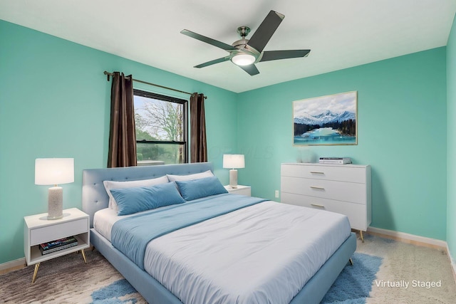 bedroom with ceiling fan and baseboards