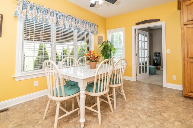 dining space with ceiling fan, visible vents, plenty of natural light, and baseboards