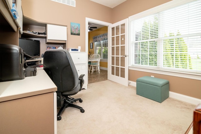 office area featuring baseboards, ceiling fan, visible vents, and light colored carpet