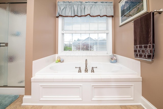 full bath with a bath and a stall shower