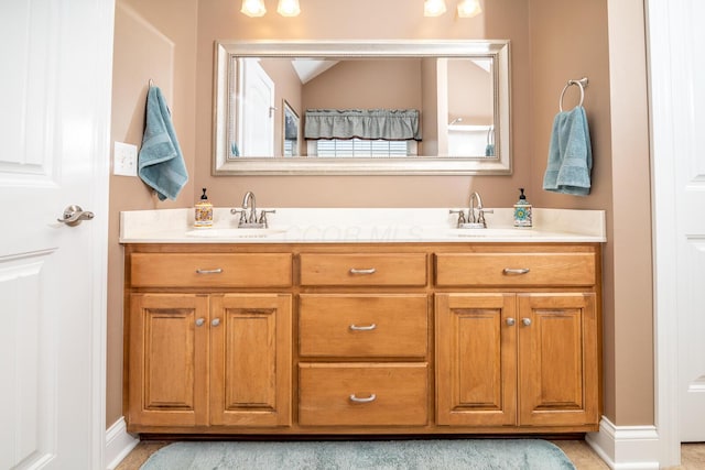 bathroom with a sink, vaulted ceiling, and double vanity