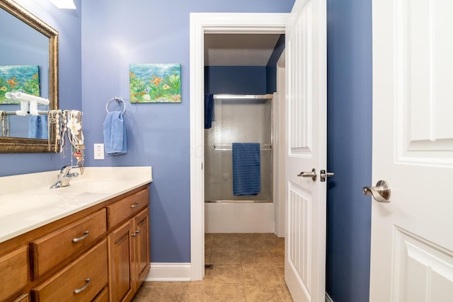 full bathroom featuring vanity, enclosed tub / shower combo, and tile patterned floors
