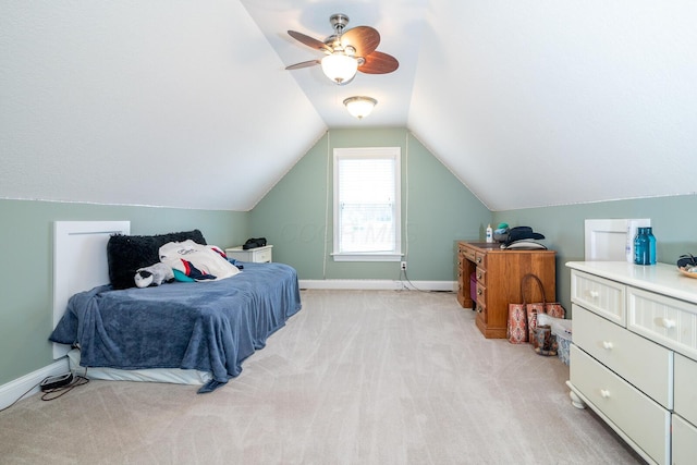 bedroom with light colored carpet, a ceiling fan, baseboards, and lofted ceiling