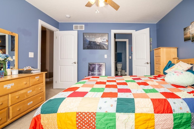 bedroom featuring a ceiling fan, visible vents, and light carpet