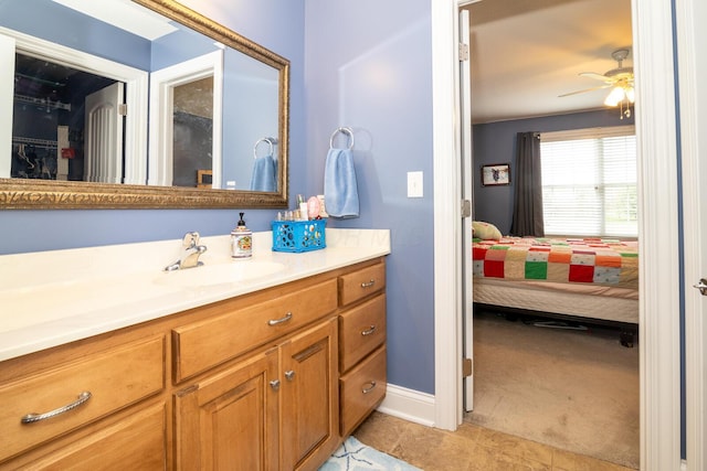 ensuite bathroom featuring ceiling fan, ensuite bath, tile patterned floors, and vanity