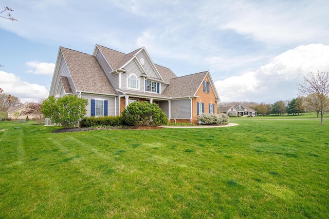 view of property exterior with a lawn, brick siding, and a shingled roof