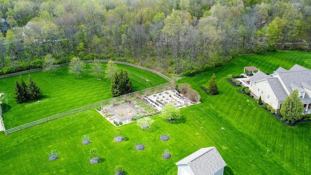 birds eye view of property featuring a view of trees