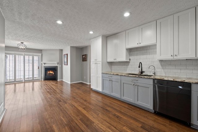 6709 Axtel Dr Unit 5A, Canal Winchester, OH 43110 - kitchen featuring a sink, open floor plan, stainless steel dishwasher, baseboards, and tasteful backsplash