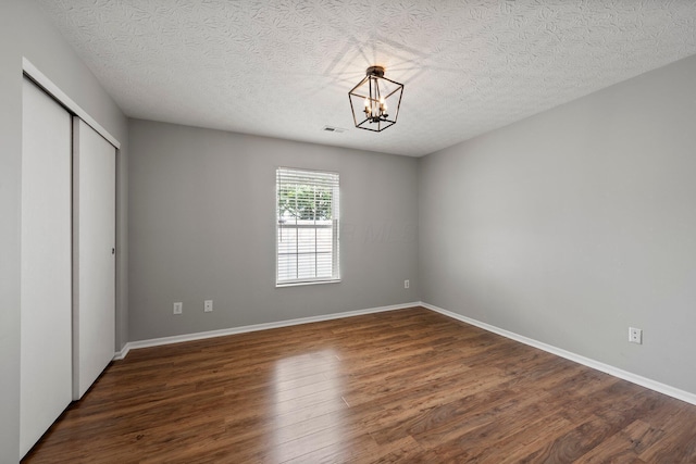 6709 Axtel Dr Unit 5A, Canal Winchester, OH 43110 - unfurnished bedroom featuring a closet, a chandelier, visible vents, and wood finished floors