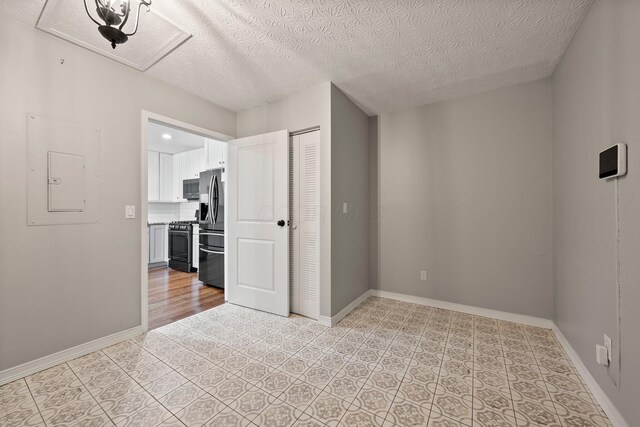 6709 Axtel Dr Unit 5A, Canal Winchester, OH 43110 - unfurnished bedroom featuring a textured ceiling, baseboards, stainless steel refrigerator with ice dispenser, and a closet