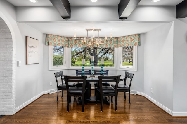 dining space with baseboards, wood finished floors, and visible vents