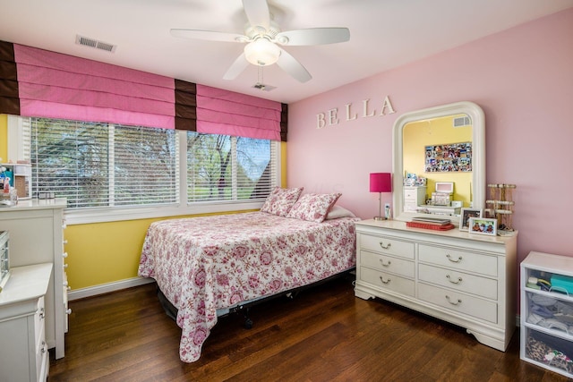 bedroom featuring visible vents, dark wood finished floors, and ceiling fan