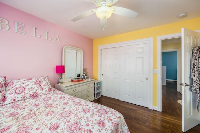 bedroom with a closet, dark wood finished floors, and ceiling fan