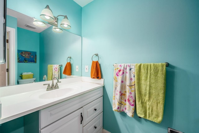 bathroom with toilet, visible vents, and vanity