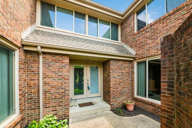 4070 Lyon Dr, Upper Arlington, OH 43220 - property entrance with french doors, brick siding, and a shingled roof