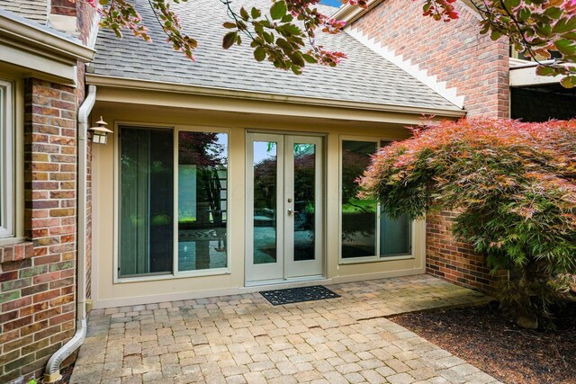 4070 Lyon Dr, Upper Arlington, OH 43220 - entrance to property with french doors, a shingled roof, and brick siding