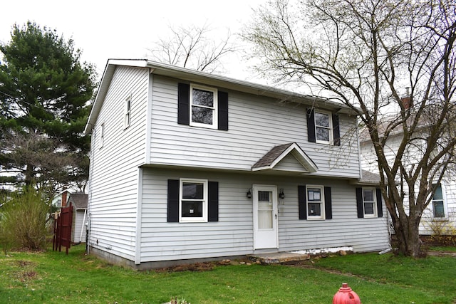colonial home with a front lawn