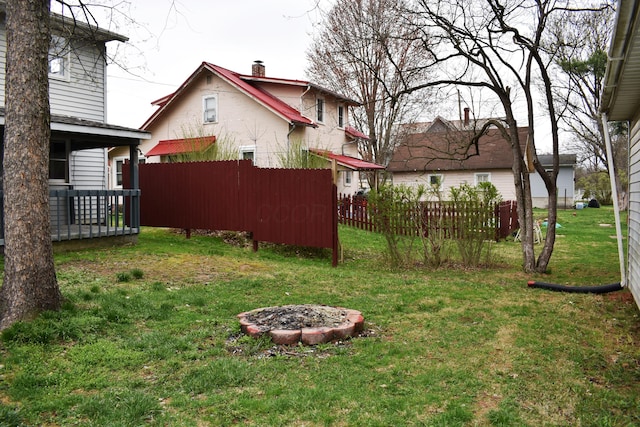 view of yard featuring fence and an outdoor fire pit