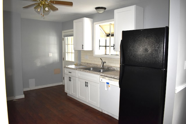 kitchen with a ceiling fan, white dishwasher, a sink, tasteful backsplash, and freestanding refrigerator