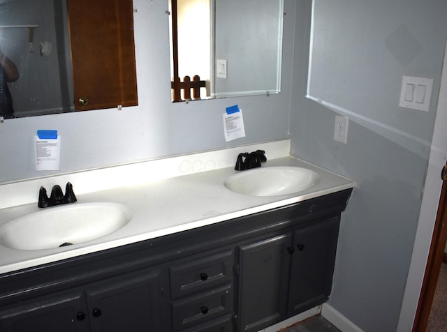 bathroom featuring double vanity and a sink