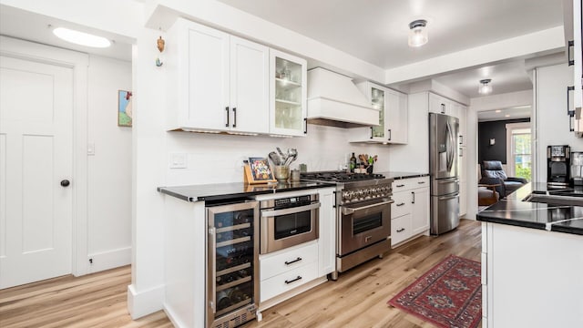 231 N Granger St, Granville, OH 43023 - kitchen with custom exhaust hood, dark countertops, appliances with stainless steel finishes, and beverage cooler