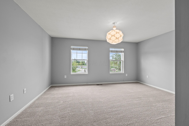unfurnished room featuring carpet flooring and baseboards