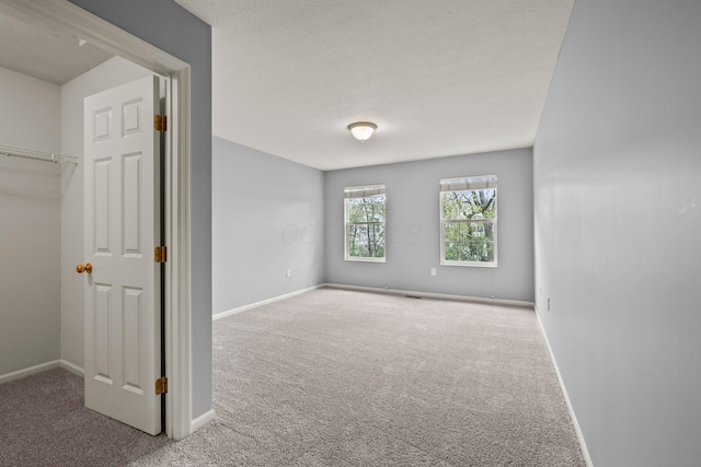 unfurnished bedroom featuring carpet flooring and baseboards