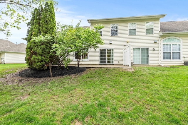 back of house with a yard and a patio