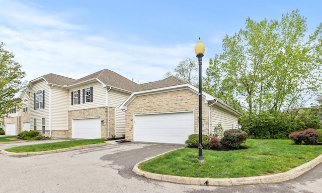 view of front of property featuring stone siding, asphalt driveway, and a front lawn