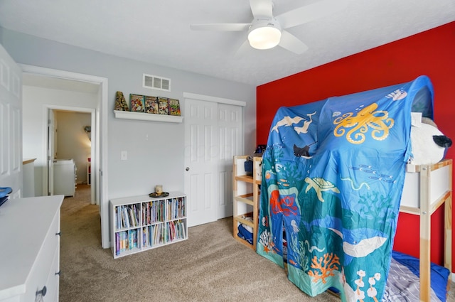 bedroom featuring carpet flooring, a ceiling fan, visible vents, and a closet