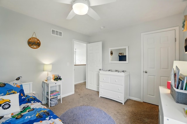 bedroom featuring light colored carpet, ceiling fan, visible vents, and baseboards