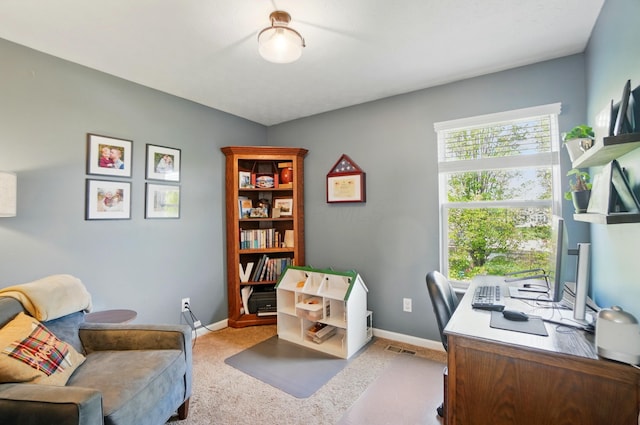 office area with baseboards, visible vents, and carpet