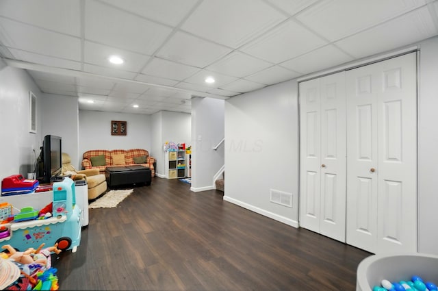 rec room featuring visible vents, baseboards, a drop ceiling, recessed lighting, and dark wood-type flooring
