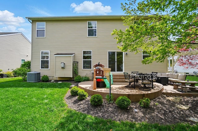 back of house with central AC, outdoor lounge area, entry steps, a patio area, and a lawn