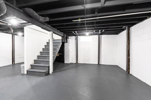 basement featuring stairs