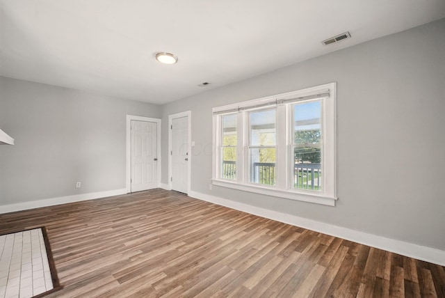 empty room with baseboards and wood finished floors
