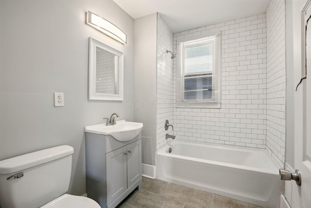 bathroom featuring toilet, vanity, and tub / shower combination