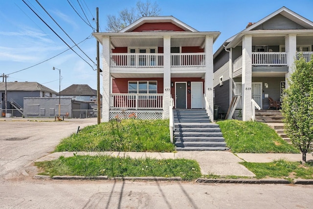 view of front of property featuring covered porch and a balcony