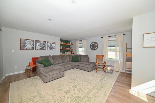 living room featuring recessed lighting, light wood finished floors, and baseboards