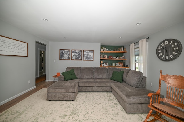 living room featuring recessed lighting, wood finished floors, and baseboards