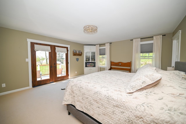 bedroom featuring french doors, light carpet, access to exterior, and baseboards