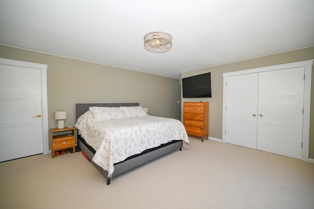 bedroom featuring a closet and light colored carpet