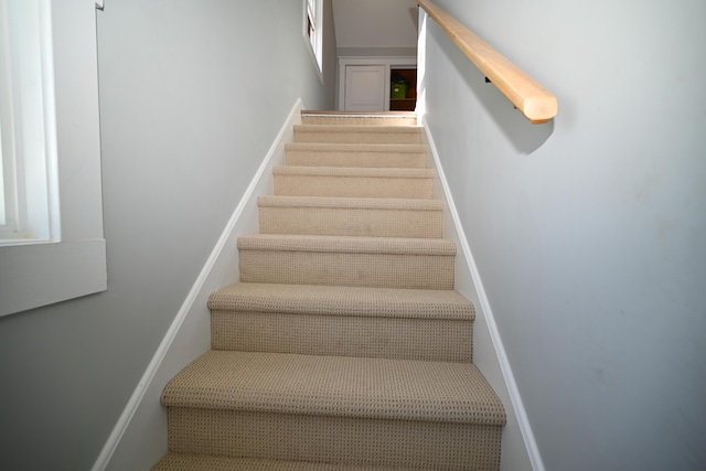 stairs featuring baseboards