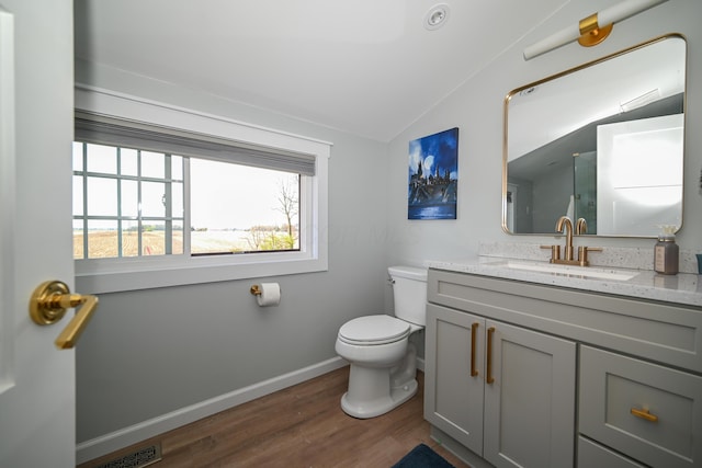 full bathroom featuring lofted ceiling, visible vents, baseboards, toilet, and wood finished floors