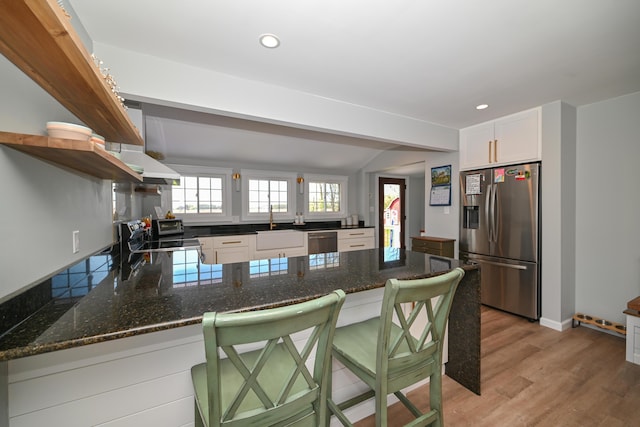 kitchen with open shelves, appliances with stainless steel finishes, a sink, white cabinetry, and a peninsula
