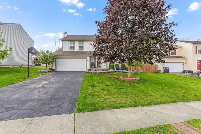 1616 Saddlebrook Dr, Heath, OH 43056 - view of front of property with a front lawn, fence, a chimney, an attached garage, and driveway