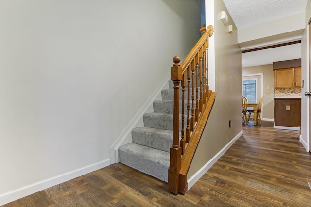 1616 Saddlebrook Dr, Heath, OH 43056 - stairway with a textured ceiling, baseboards, and wood finished floors