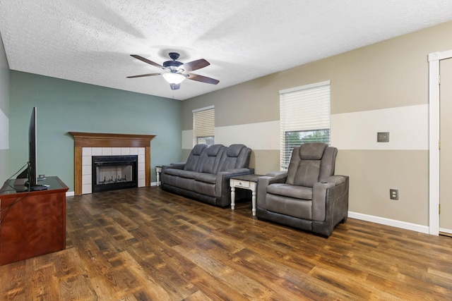 1616 Saddlebrook Dr, Heath, OH 43056 - living room with a fireplace, a textured ceiling, a ceiling fan, baseboards, and wood finished floors