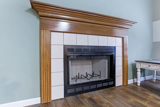1616 Saddlebrook Dr, Heath, OH 43056 - room details featuring a tiled fireplace, baseboards, and wood finished floors